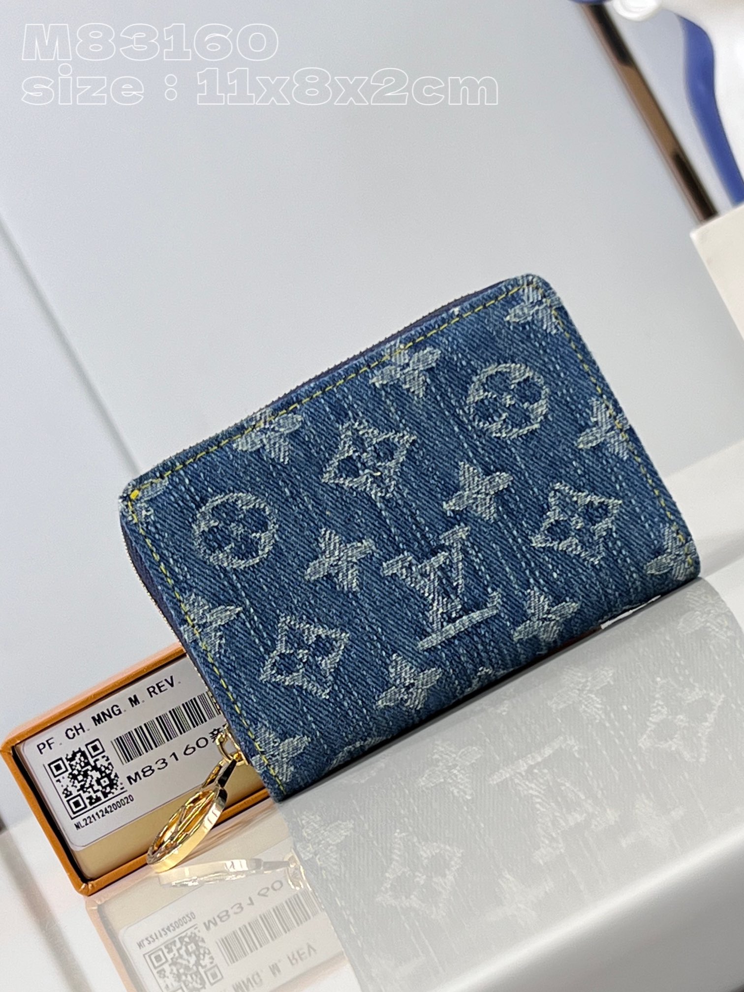 Louis Vuitton Denim wallet with Monogram print, gold-colored LV circle pull handle and zipper in the same color